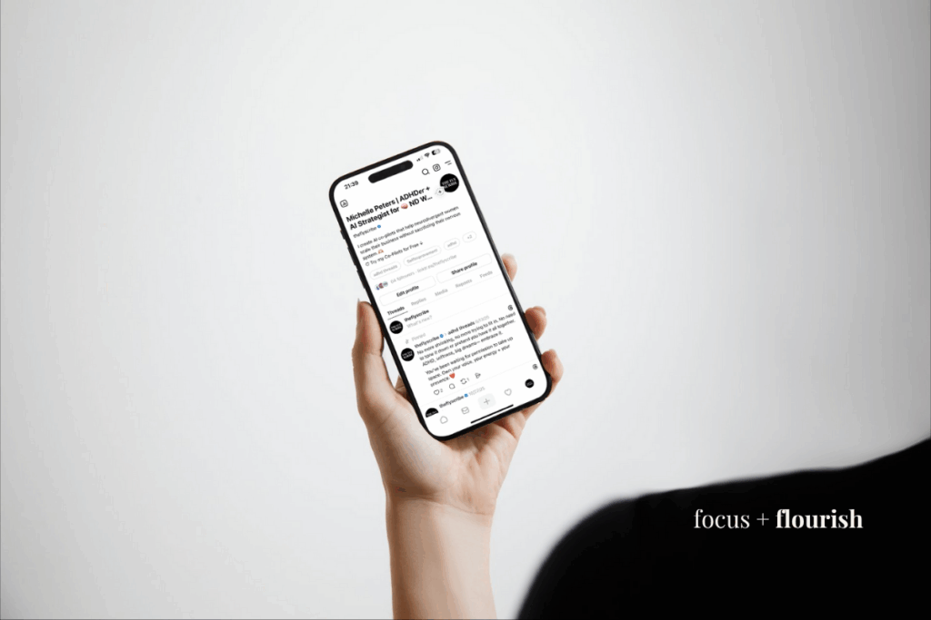 woman holding phone using threads app